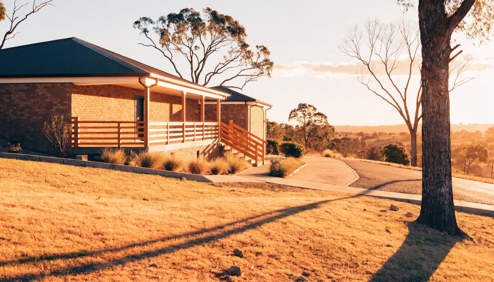 A completed home with a fresh concrete driveway at dusk