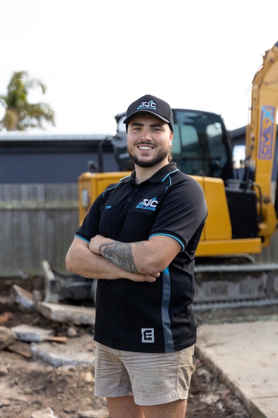 Tyler Clarke, owner of TJC Building, on site in front of the company excavator in North-West Tasmania