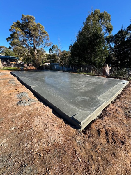 A freshly poured concrete shed slab by TJC Building