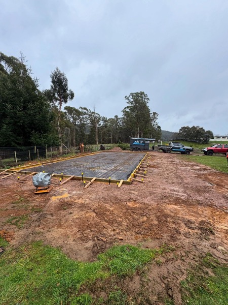 A large concrete pad poured by TJC Building on a rural property