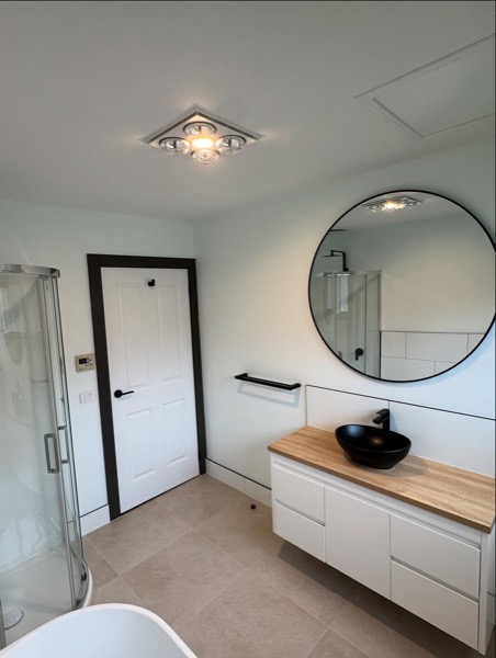 A renovated bathroom with new shower and vanity by TJC Building