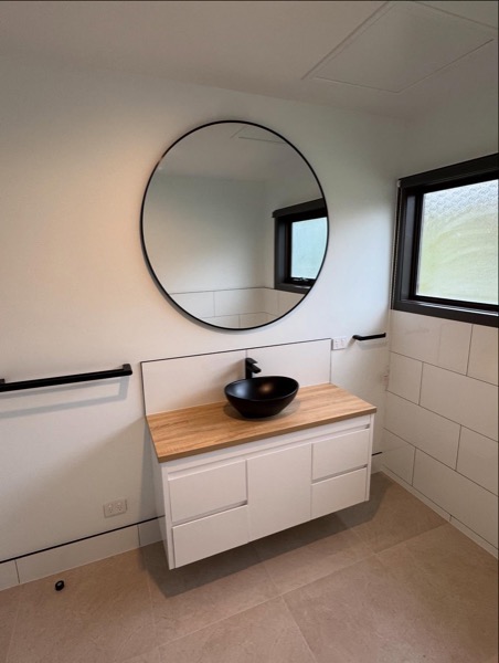 A renovated bathroom with new vanity and basin by TJC Building