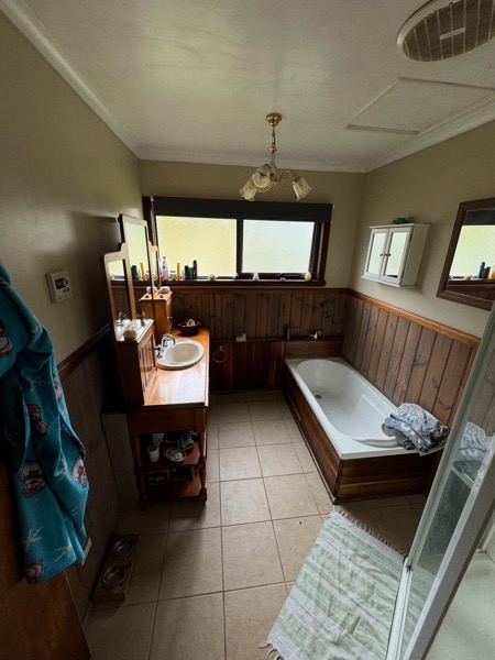 An original timber-panelled bathroom before a TJC Building renovation