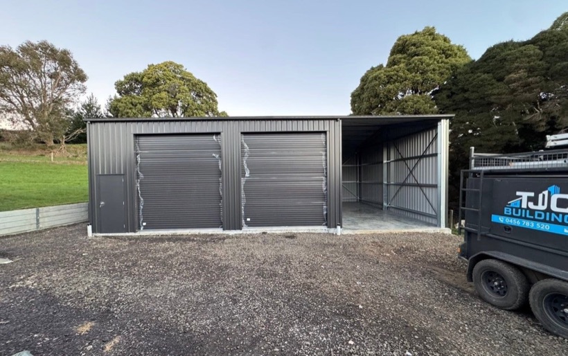 A finished shed with roller doors and the TJC Building trailer on site