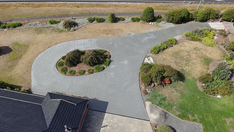 An aerial view of a curved concrete driveway poured by TJC Building
