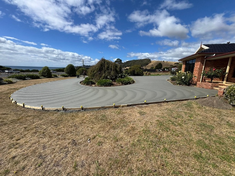 A finished curved concrete driveway by TJC Building seen from above