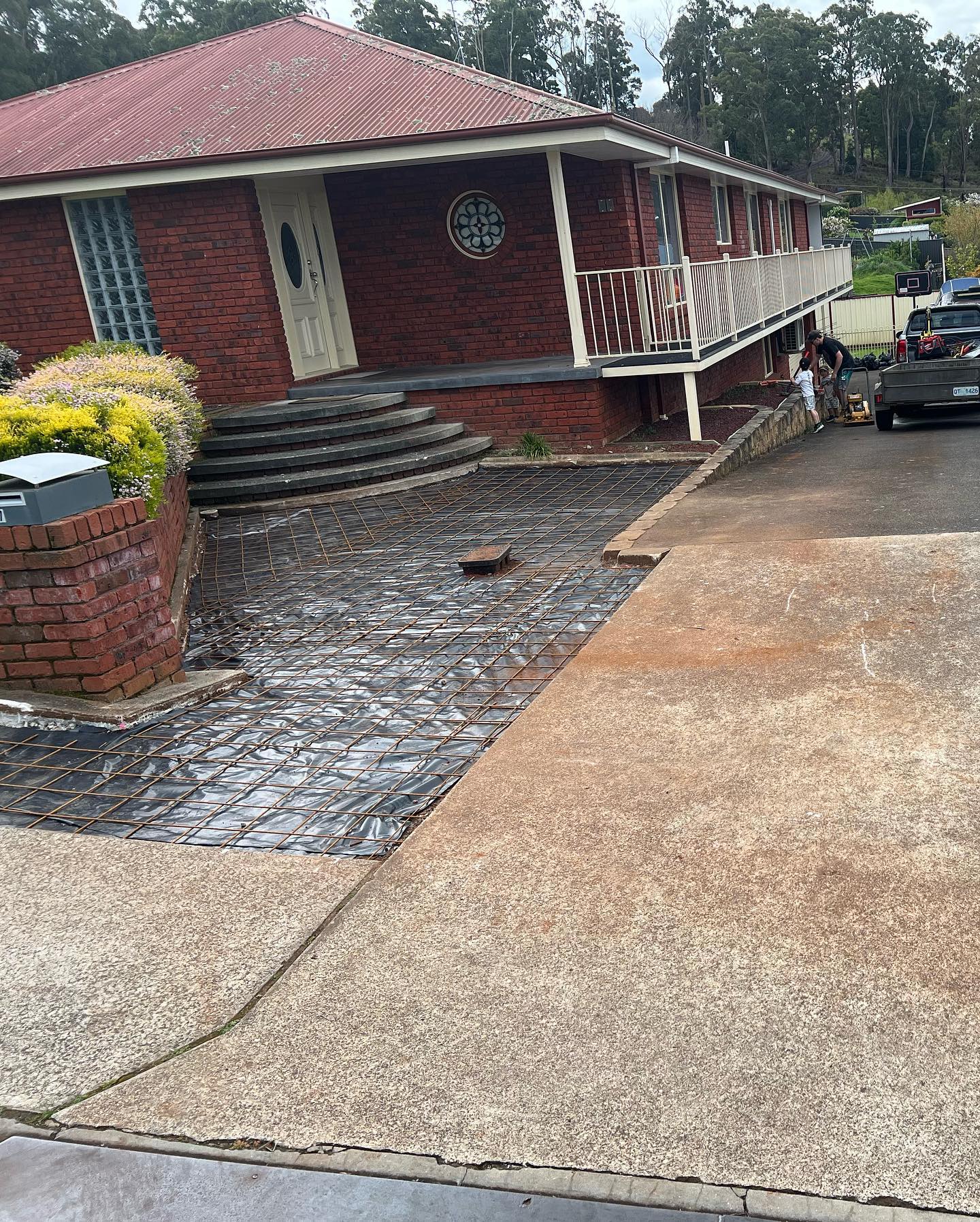 A finished concrete driveway poured by TJC Building at a Devonport home