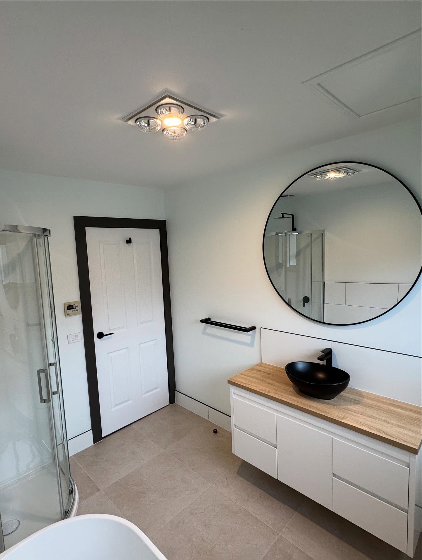 A renovated bathroom with new shower and vanity by TJC Building