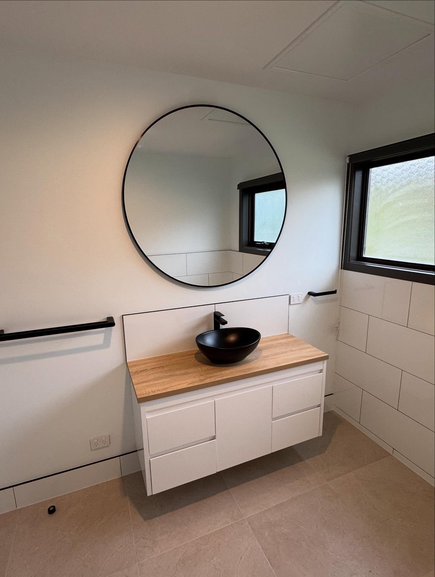 A renovated bathroom with new vanity and basin by TJC Building