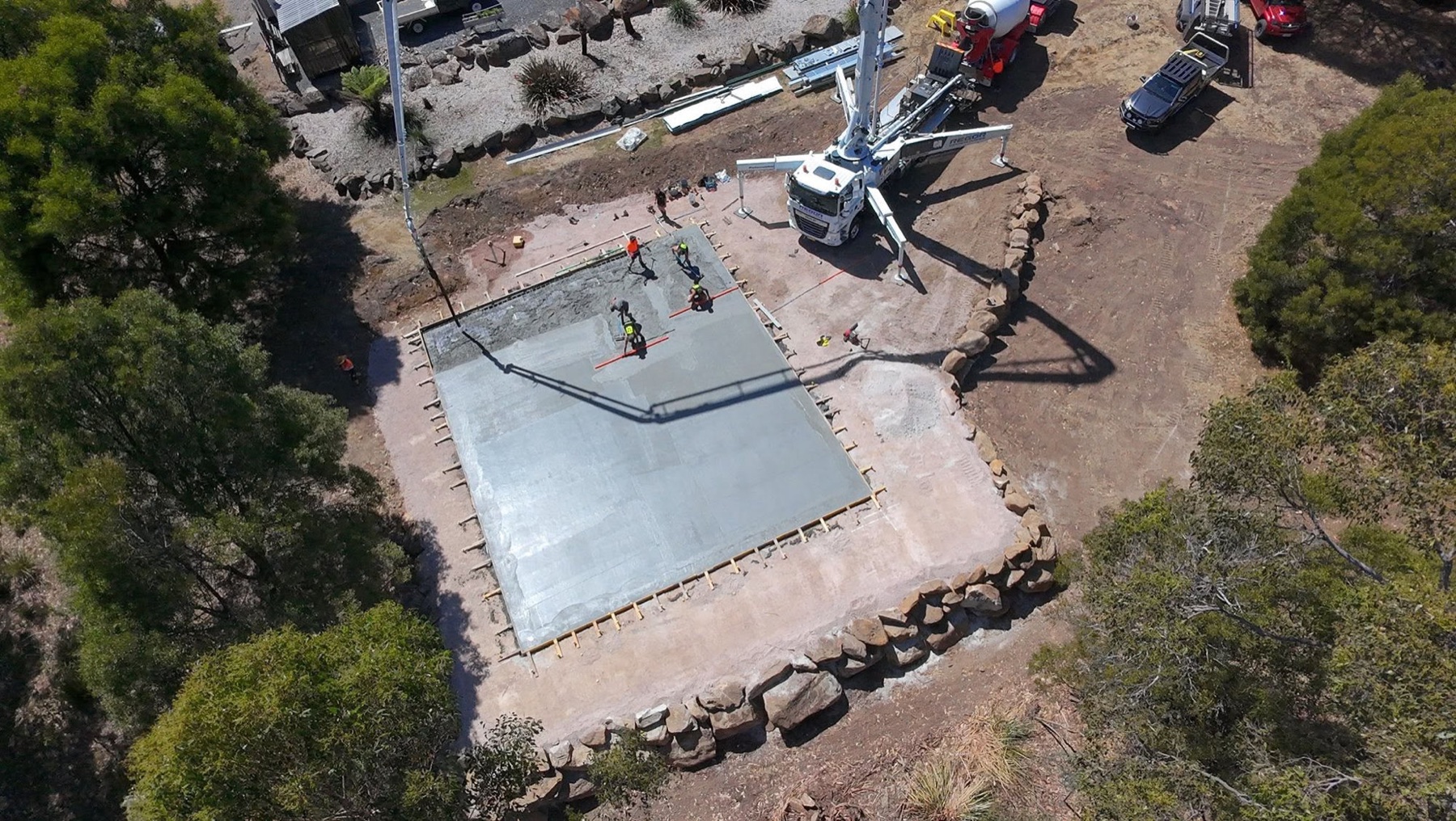 An aerial view of the TJC Building crew pouring a large concrete slab in North-West Tasmania